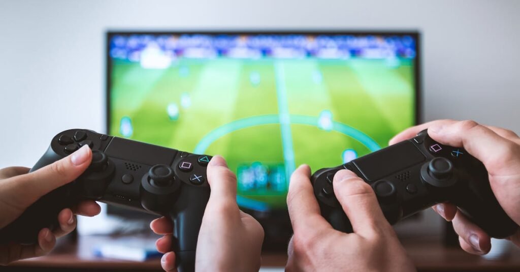 Close-up of hands holding gaming controllers in front of a TV. Engaged in a video gaming session.